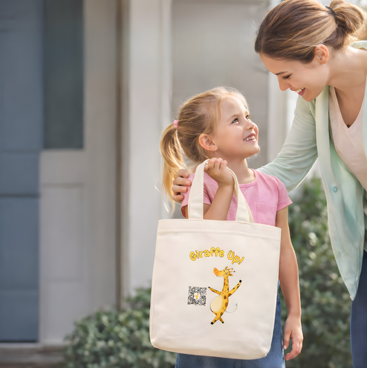 Woman and child holding a tote bag with Gertie the Brave Giraffe character, standing outdoors.
