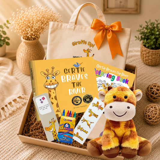 A curated gift box set featuring a beige tote bag with an orange bow, a yellow children's coloring book titled 'Gertie Bravoes the Bear Coloring Book', a matching coloring book titled 'Gertie Bravoes the River', a small plush giraffe toy, a pack of colorful pencils, sticker sheets, and a small card, all arranged in a box on a woven mat with decorative plants in the background.