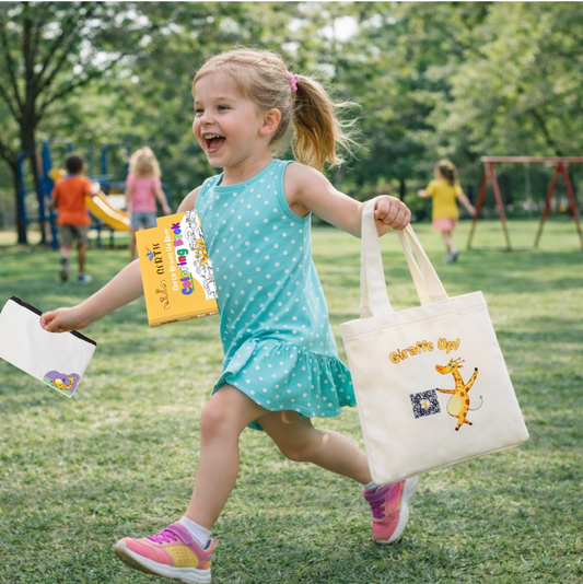Child in a park holding The Brave Storytime Bundle's tote bag with Gertie the Giraffe book and coloring book, at the playground.